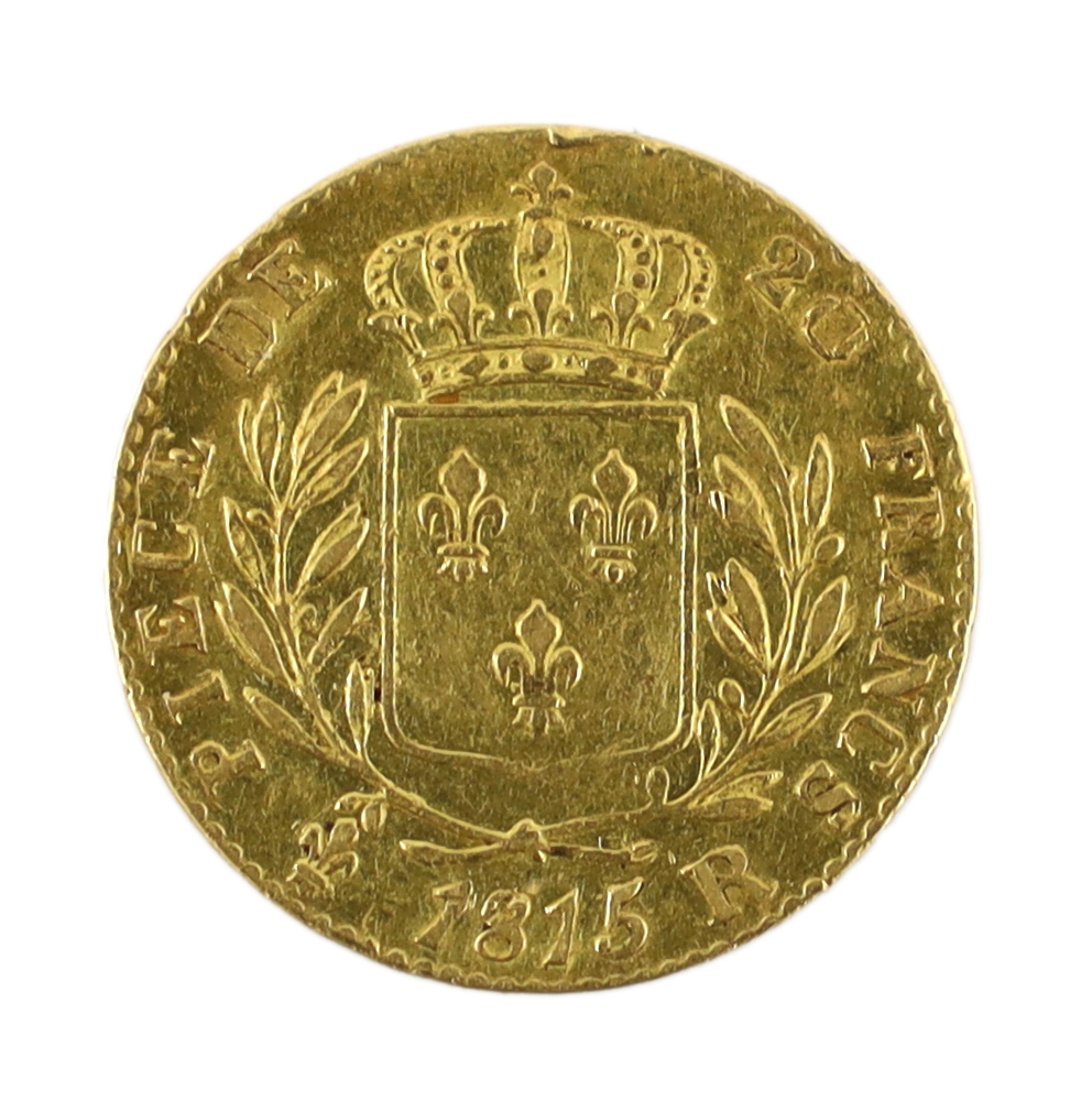 Gold coins, Louis XVIII 20 Francs London Mint, 1815R, probably demounted at the 12 o’clock position, otherwise good VF